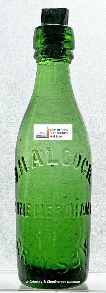A bottle belonging to wine merchant John Henry Alcock of Grimsby c1894-1910s