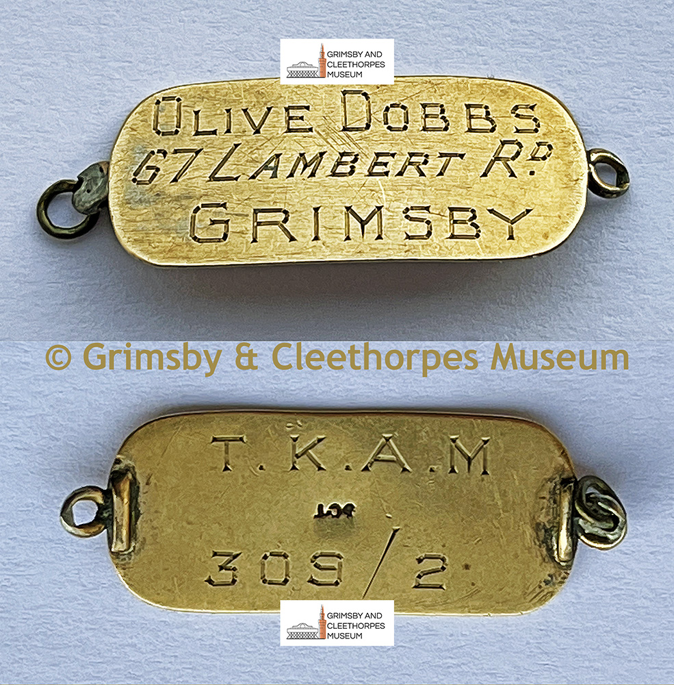 Inscribed tag from a gold, WW2 identity bracelet; Olive Dobbs (1894-1972) of Lambert Road, Grimsby