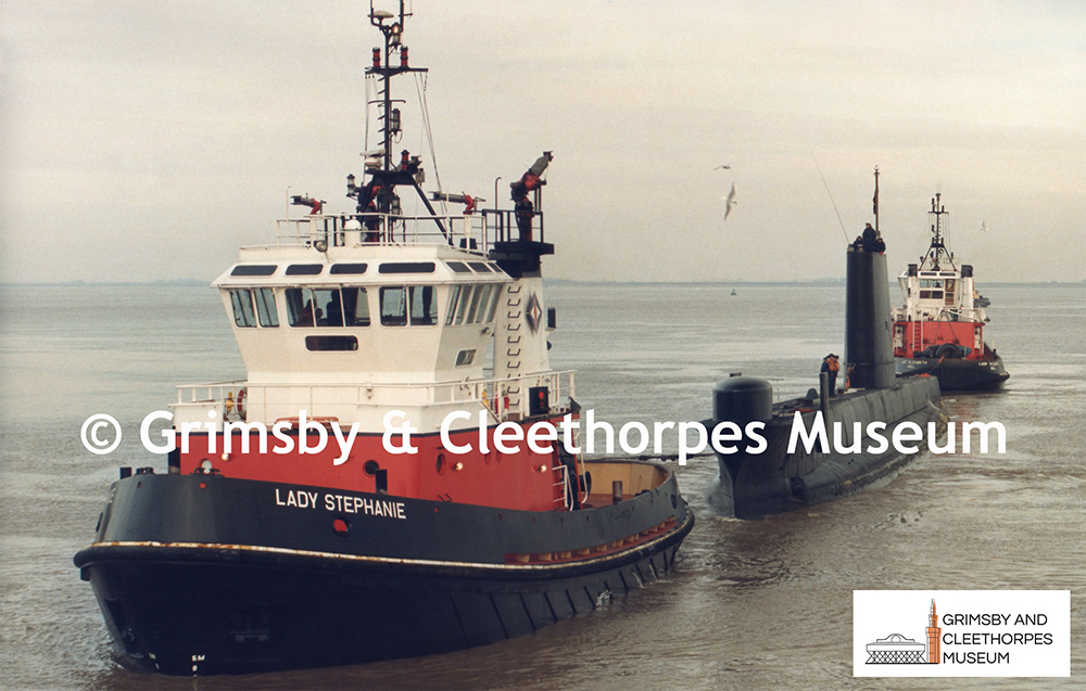 Royal Navy submarine being assisted into Immingham Docks 1987